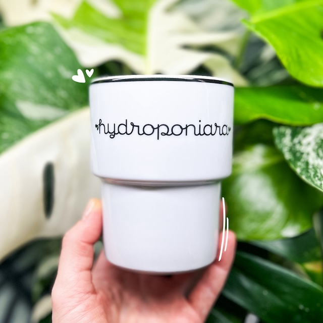 A white mug with the word &quot;Hydroponiara&quot; (meaning a hydroponics girl) on it.